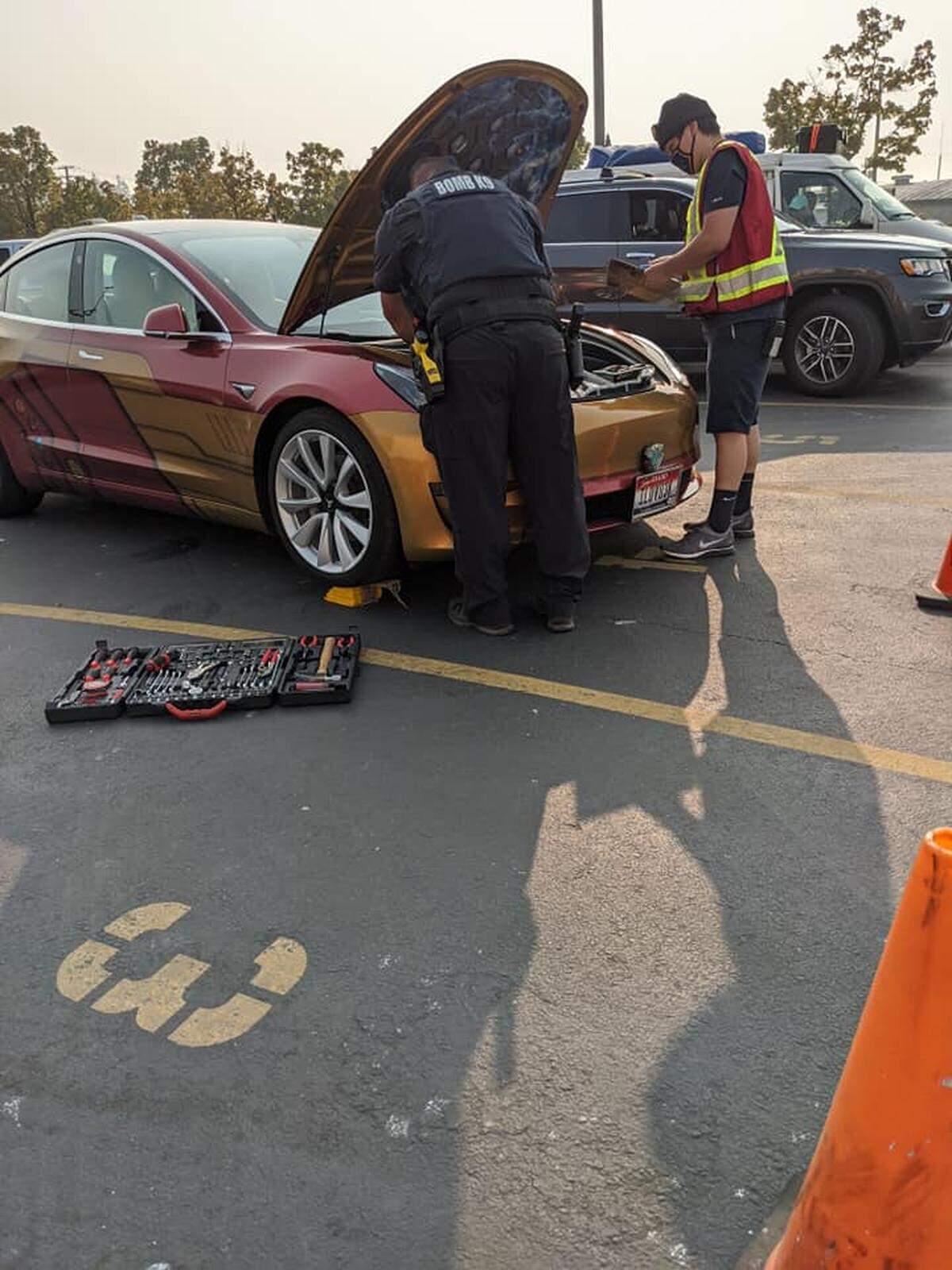 A U.S. Customs and Border Protection officer and an Alaska Marine Highway ferry staff member work to disassemble the “frunk” in Len Anderson’s Tesla Sept. 11 in Bellingham. While waiting to board the ferry, a kitten climbed into the Tesla and attempted to stow away.