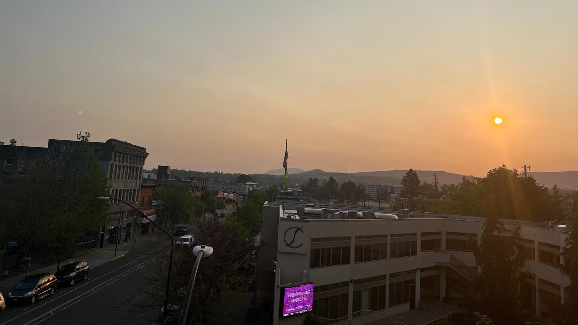 WIldfire smoke in the upper atmosphere causes a hazy sunrise over downtown Bellingham, Wash., on Wednesday, May 17, 2023.