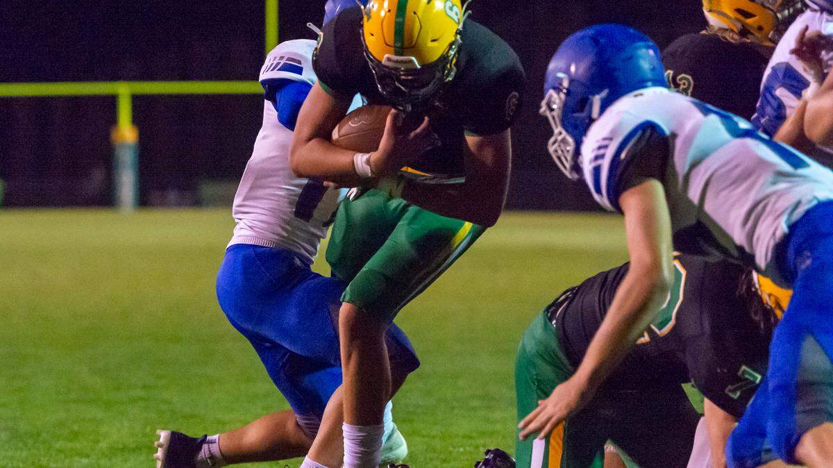 Lynden quarterback Brant Heppner (6) runs by Sedro-Woolley defenders into the endzone for a touchdown with only 55 seconds left in the game to give the Lions a 23 to 21 lead over Sedro-Woolley on Friday evening Sept. 23, 2022, at Lynden High School in Lynden, Wash.
