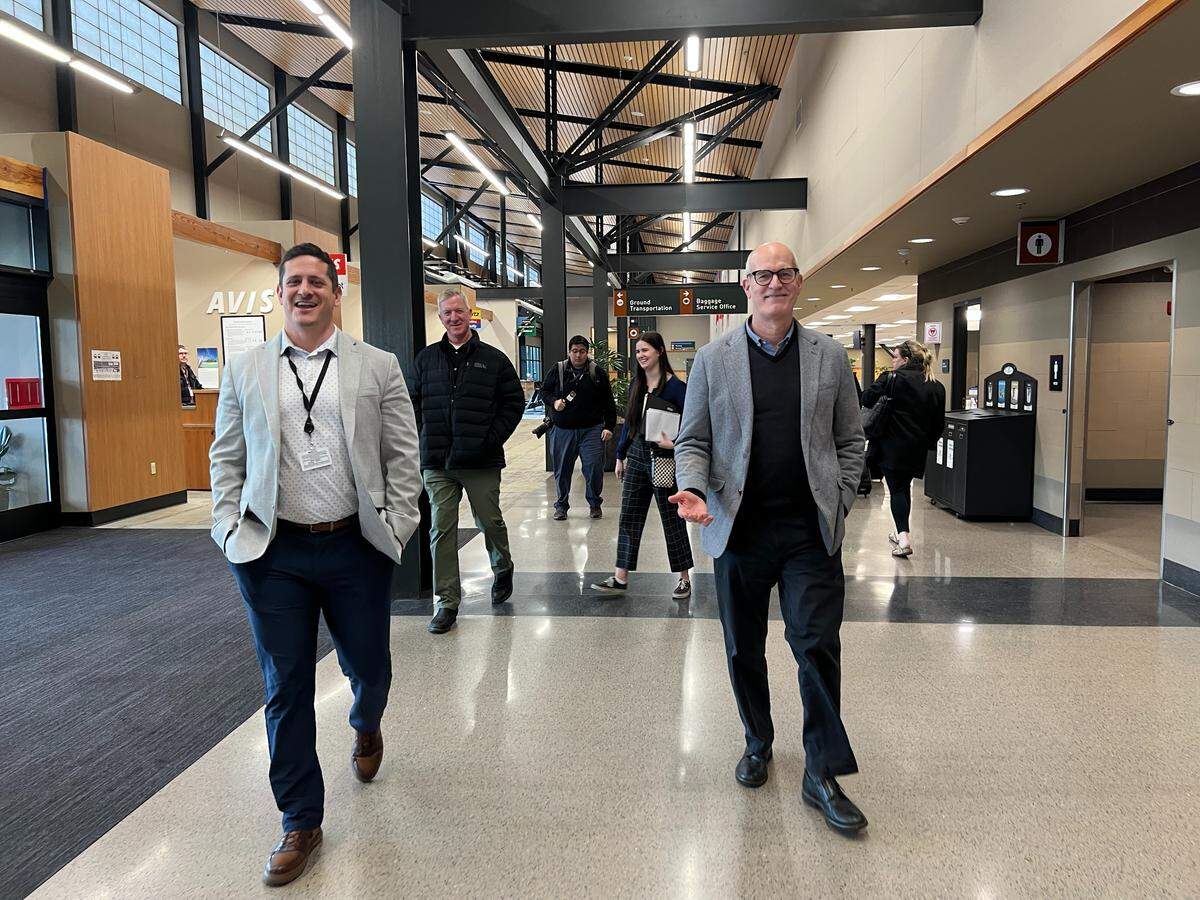 Matthew Rodriguez, left, walks through the airport with 2nd Congressional District U.S. Rep. Rick Larsen, D-Everett, on Tuesday in Bellingham.
