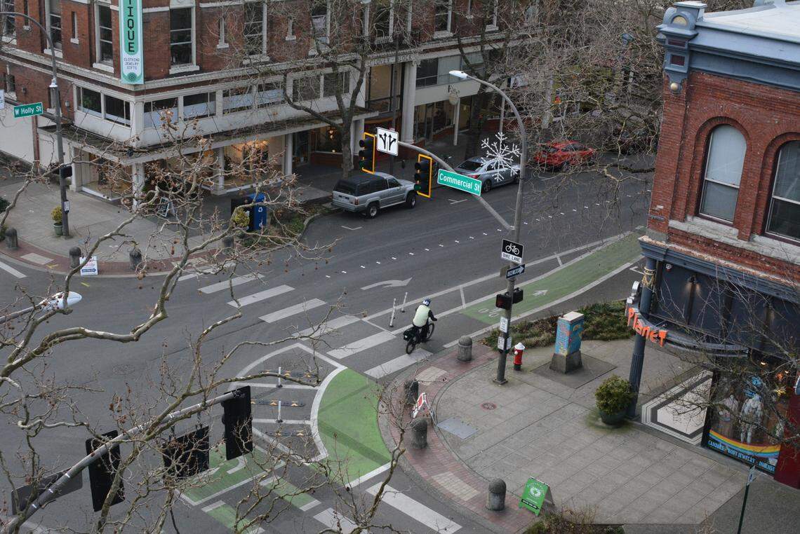 A bicyclist on Holly Street crosses Commercial Street in downtown Bellingham, as seen from the Commercial Street parking garage. 
