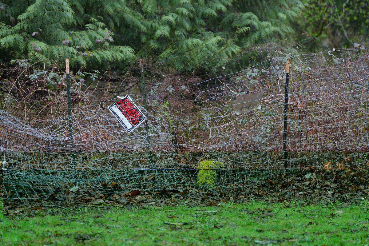 Fencing on private property at an apartment complex is cut on March 18, 2026, directly next to a “No Trespassing” sign as a result of encampment activity in the nearby woods in Bellingham, Wash. The on-site property manager said they are doing everything to keep encampment activity off their property, but efforts have come at a huge financial toll.