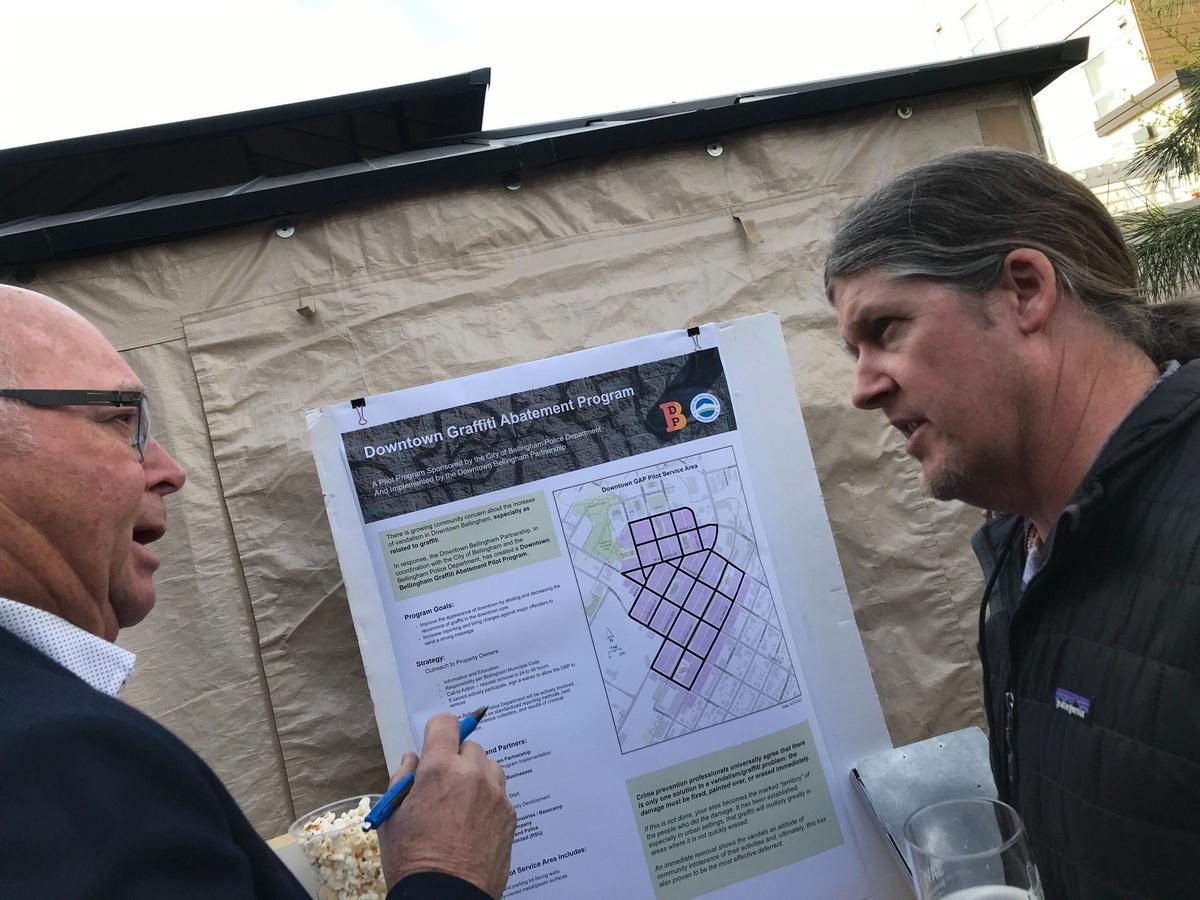 Downtown Bellingham businessman John Templeton, left, and Kenny Austin, who supervises the Downtown Bellingham Partnership’s landscaping and maintenance crew, discuss graffiti and other topics at a Downtown Bellingham meeting on Thursday, April 21, at Boundary Bay Brewery in Bellingham.
