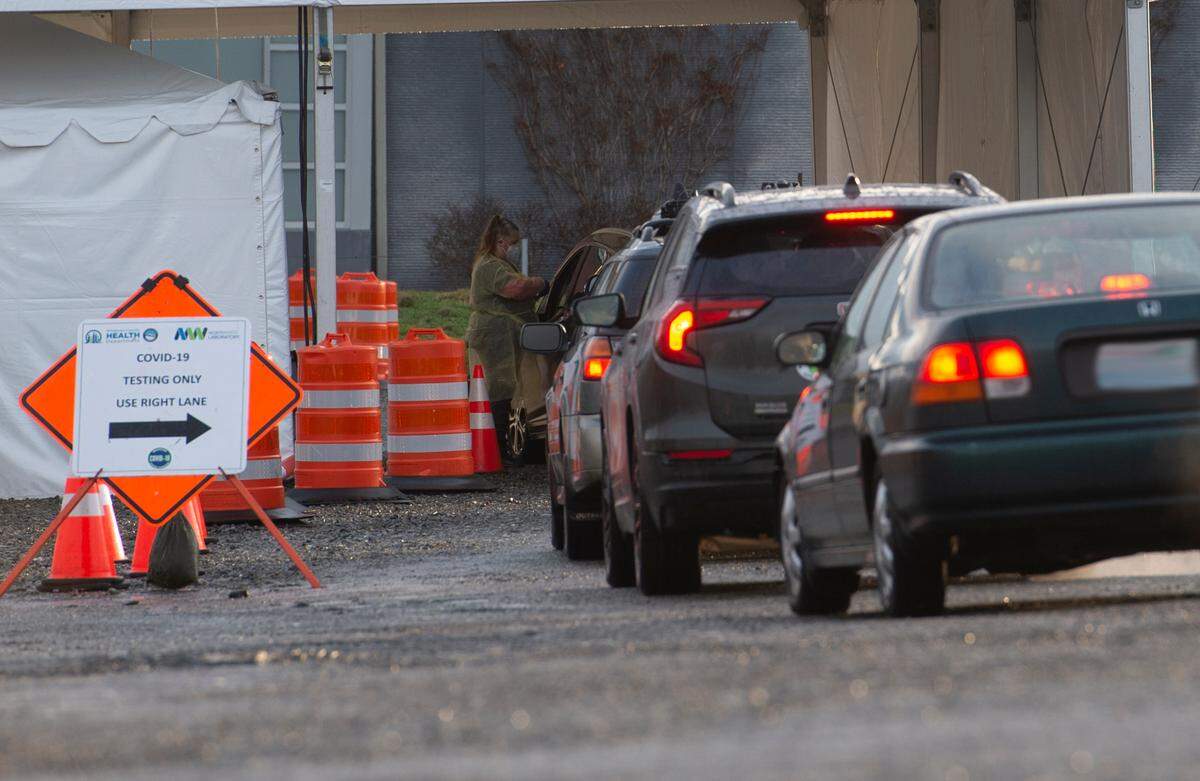People line up in their cars to be tested for COVID-19 on Thursday, Jan. 13, in Bellingham. The Whatcom County Health Department operates the drive-through community testing site at Bellingham International Airport, Economy Lot B. Appointments are required for testing at the site.