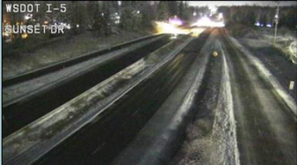 The pavement along Interstate 5 at Sunset Drive appears wet but clear of snow about 5 a.m. Thursday, Feb. 24, in Bellingham.