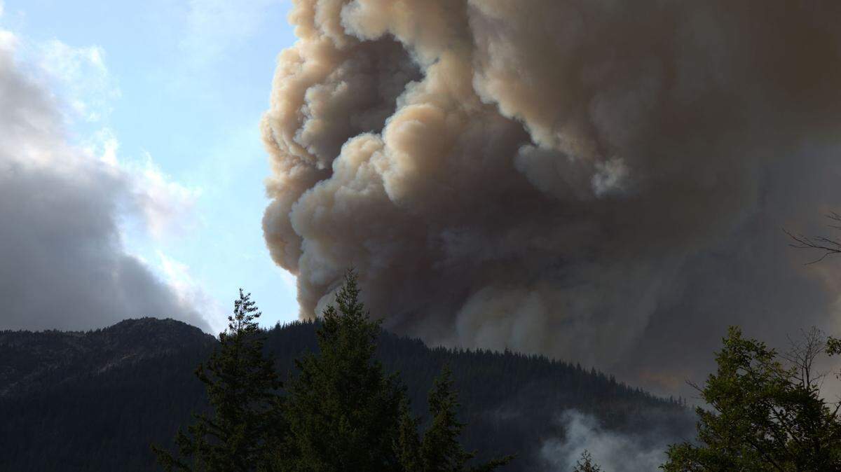 Smoke rises from a wildfire on Sourdough Mountain near Diablo in eastern Whatcom County on Sunday.