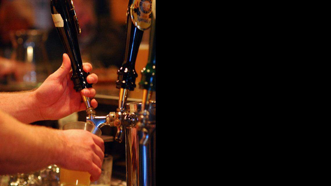 James Hardesty pours a Snipes Mountain brew from the tap at the Green Frog Acoustic Cafe on May 7, 2010.