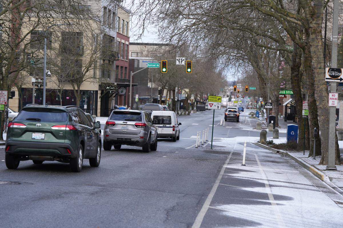 Vehicles drive through downtown on February 3, 2025, amid a cold spell that left a light dusting of snow in Bellingham, Wash.