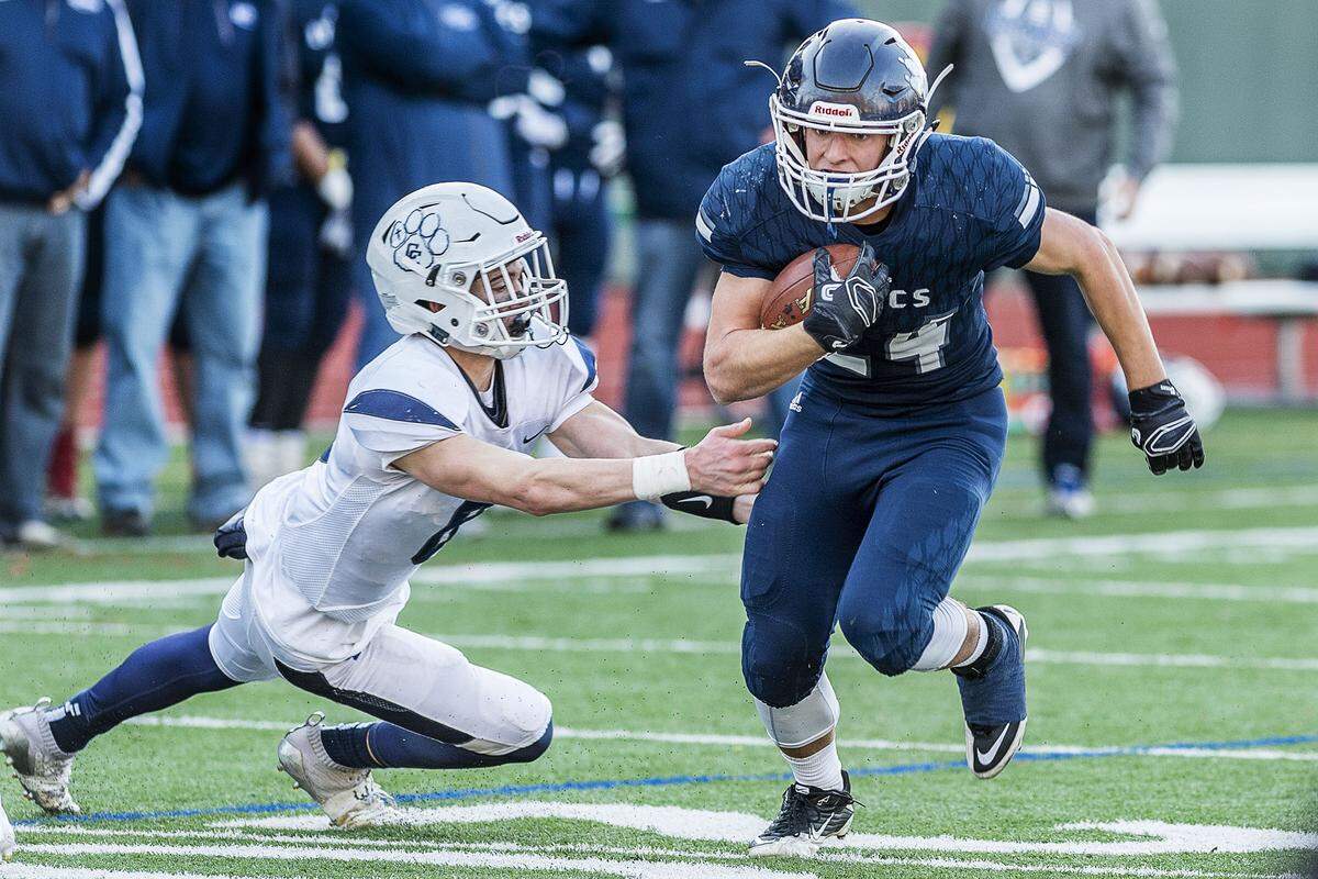 Lynden Christian running back Levi Korthuis (24) sweeps the corner as he evades Cascade Christian defensive back Michael Gurr (6) during the fourth quarter of the 1A State playoff opener on Saturday afternoon Nov. 10, 2018, at Civic Stadium in Bellingham.