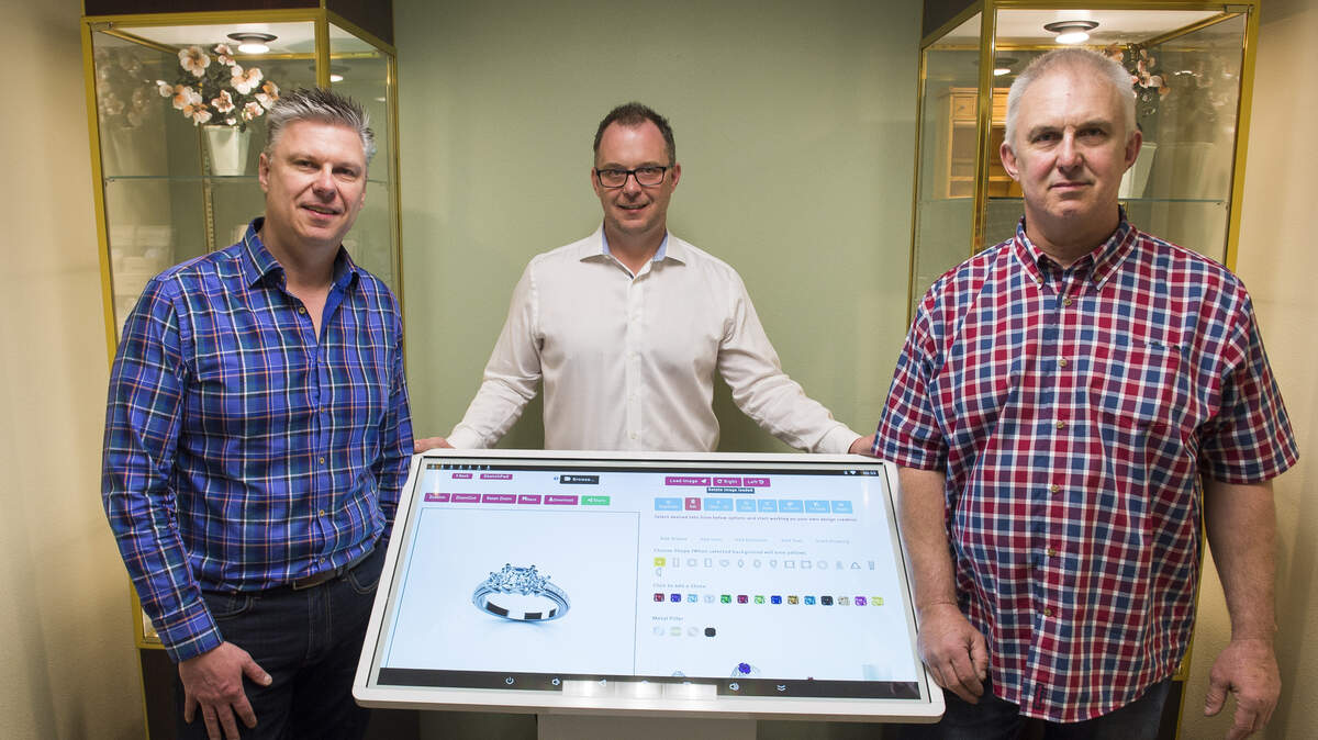 Bayside Coin and Jewelry owners Charles Neeter, left, John Neeter and Robert Neeter at their Custom Studio touchscreen on Thursday, April 26, in Bellingham. Custom Studio allows customers to modify existing jewelry by uploading a photo or create new jewelry from scratch either in the store or on an app on mobile devices.