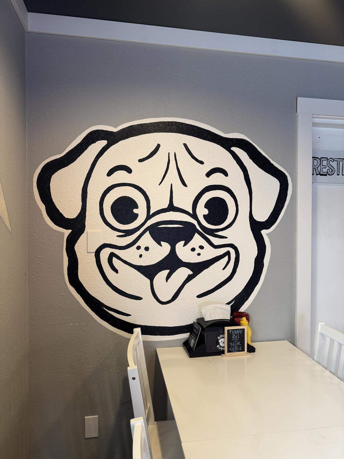 A mural inside of Doug’s Burgers shows the restaurant’s mascot, Doug, the restaurant owner Matt King’s dog, on March 11, 2026, in Bellingham, Wash.