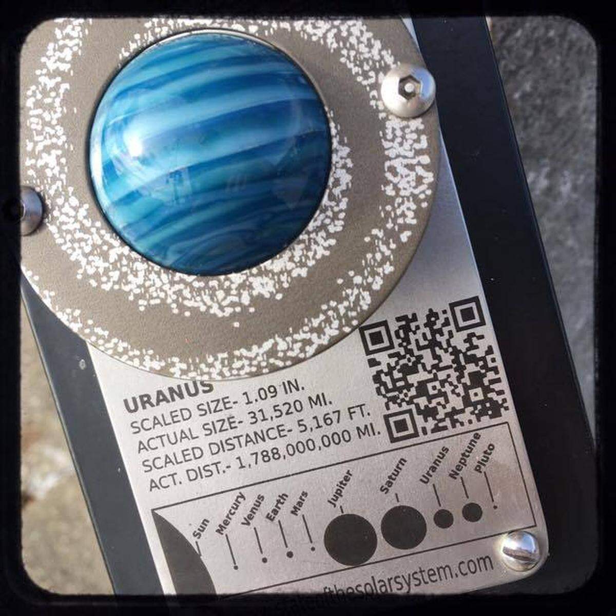 A marble fashioned to resemble the planet Uranus was mounted on a pedestal near North State and East Chestnut streets in downtown Bellingham in 2016 as part of an art project . The marble was stolen, ong with several others, in November 2018.