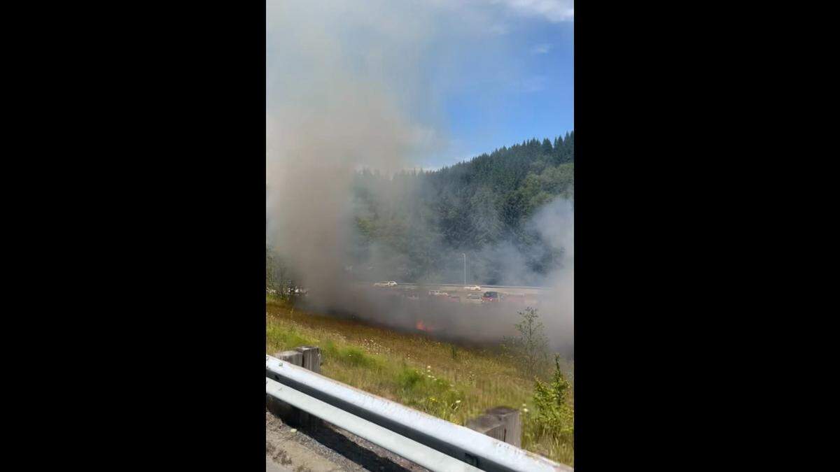 A brush fire burns along I-5 South near Bellingham on July 27, 2023.