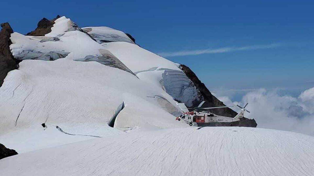 A helicopter from U.S. Naval Air Station Whidbey Island lands Sunday, July 18, near the 9,000-foot level of Mount Baker to rescue an injured hiker.