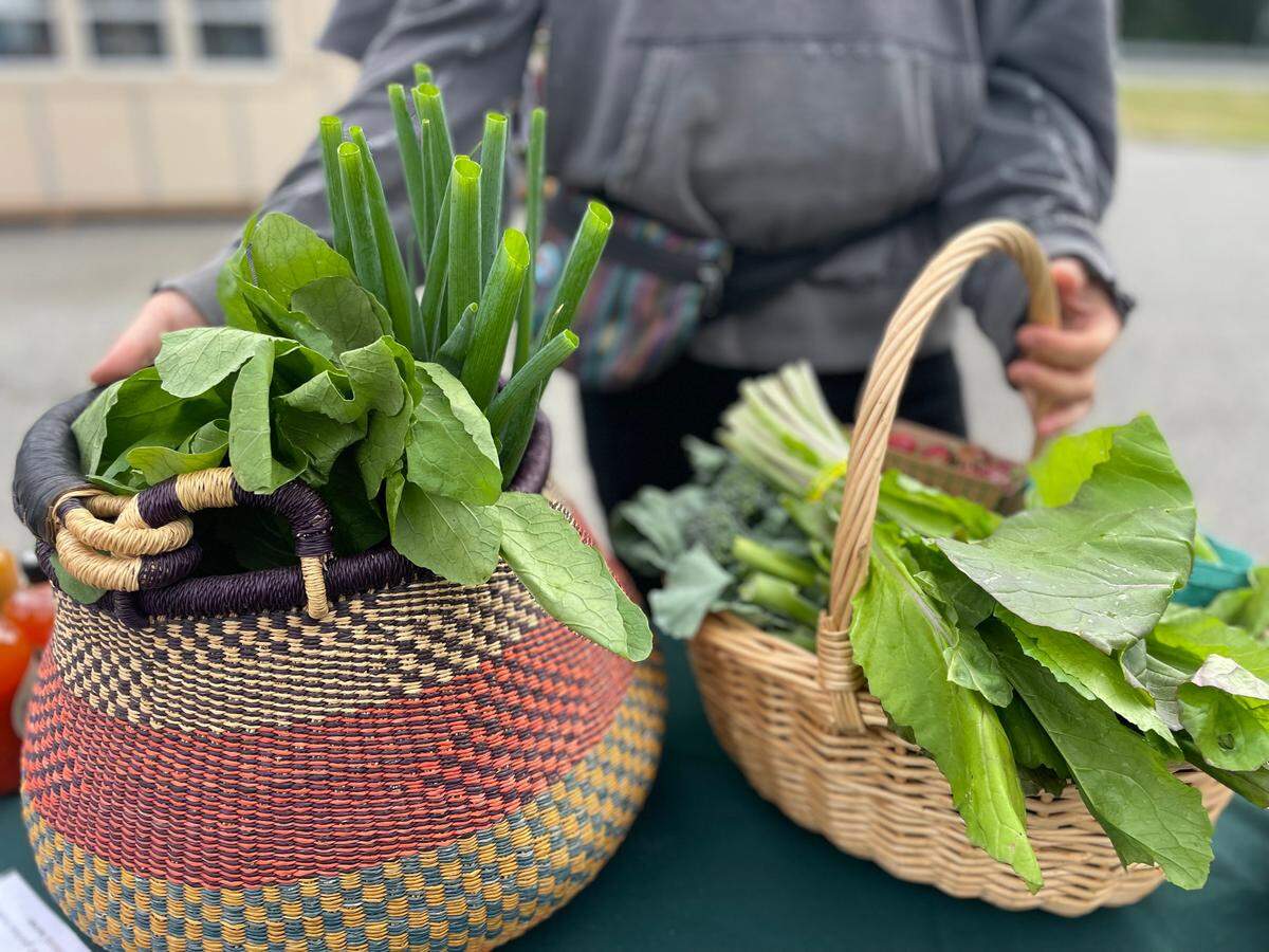 A Twin Sisters Mobile Market customer walks away with fresh produce from the market pop-up in Deming, Wash.