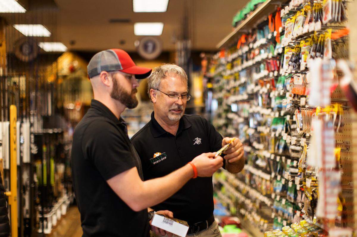 Dave VanderHoek, right, and Will Lathrop look over some merchandise at Dave’s Sports Shop in Lynden. Lathrop and his family took over ownership of the longtime business on Sunday, May 1. VanderHoek plans to retire and do some traveling.