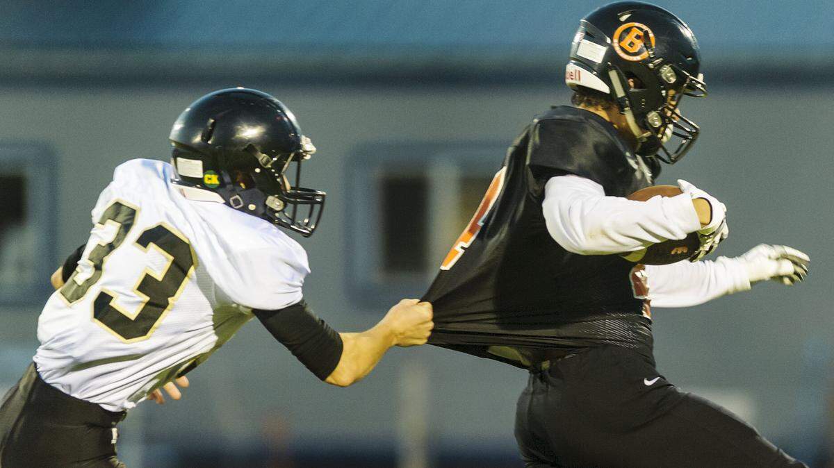 Meridian’s Dylan Hickok, left, holds up Blaine wide receiver Chase Abshere in a 2017 game. Hickok is one of what coach Bob Ames calls his “Swiss Army knives” as the Trojans prepare to host Colville in the Class 1A state quarterfinals Saturday at Civic Stadium.