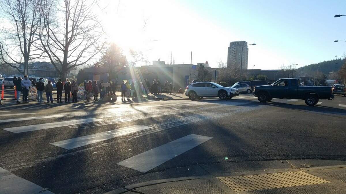 Protesters and advocates for homeless have created a human barrier across Grand Avenue in front of the Whatcom County Courthouse and are blocking cars from going through Friday morning, Jan. 22, in Bellingham.