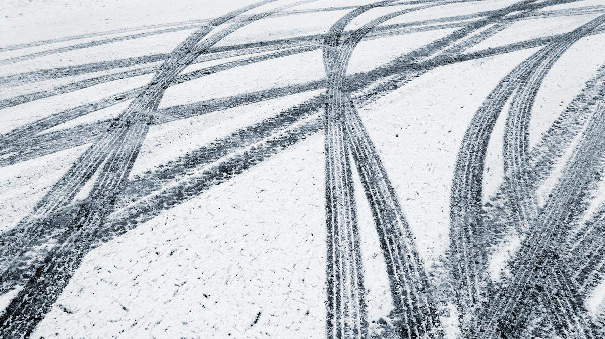 Cars leave their mark in the fresh fallen snow.