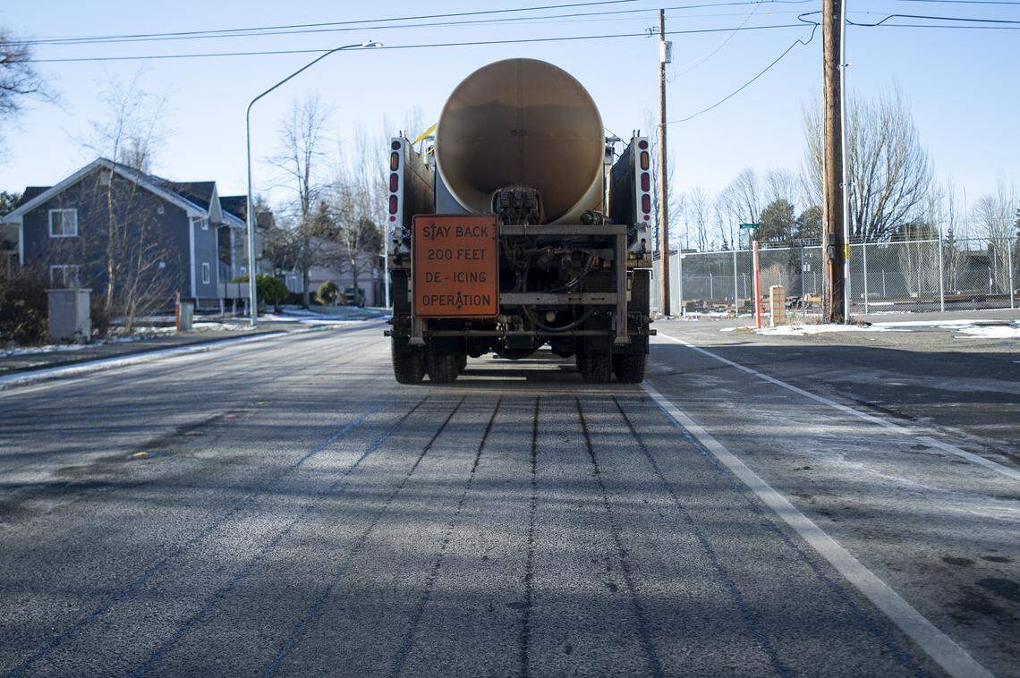 A Bellingham Public Works Department de-icing truck sprays a de-icing agent on Fraser Street in Bellingham, Wash. on Feb. 6, 2019. The agent, which is made with beat juice so it’s environmentally friendly, creates a barrier so snow and ice can’t bond to the pavement.
