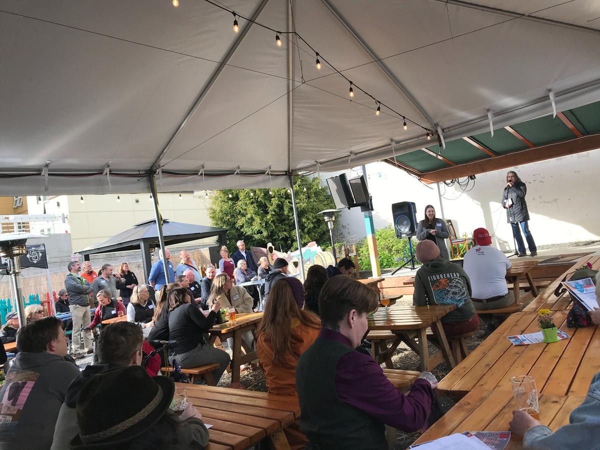 Downtown Bellingham Partnership Executive Director Alice Clark, on stage, discusses graffiti and other topics at Boundary Bay Brewery during a Downtown Bellingham meeting on Thursday, April 21, in Bellingham.