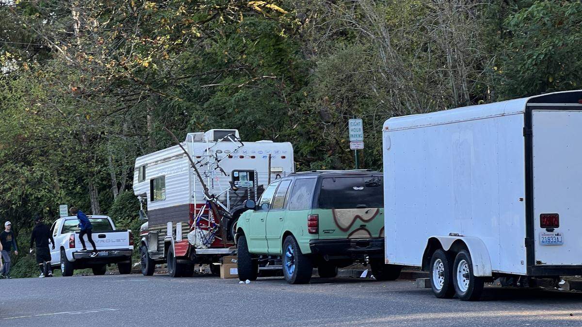Cars, trailers and RVs line Moore Street on Tuesday, around the corner from Carl Cozier Elementary School, where 8-hour parking signs were posted recently.