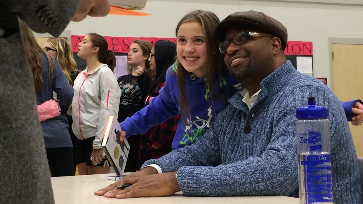 Acclaimed poet and writer Kwame Alexander, right, is shown with a young fan as he signed copies of “The Crossover” and other books after an appearance in October 2015 at Bellingham High School.