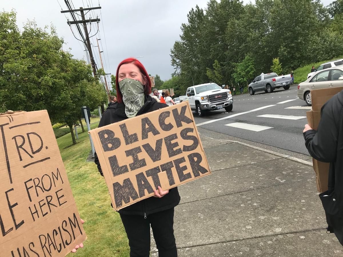 Bellingham City Council member Hollie Huthman joins protesters that line the sidewalks at a protest against racial injustice and inequality experienced by people of color Friday afternoon, June 12, at the intersection of West Bakerview Road and Arctic Avenue in Bellingham.