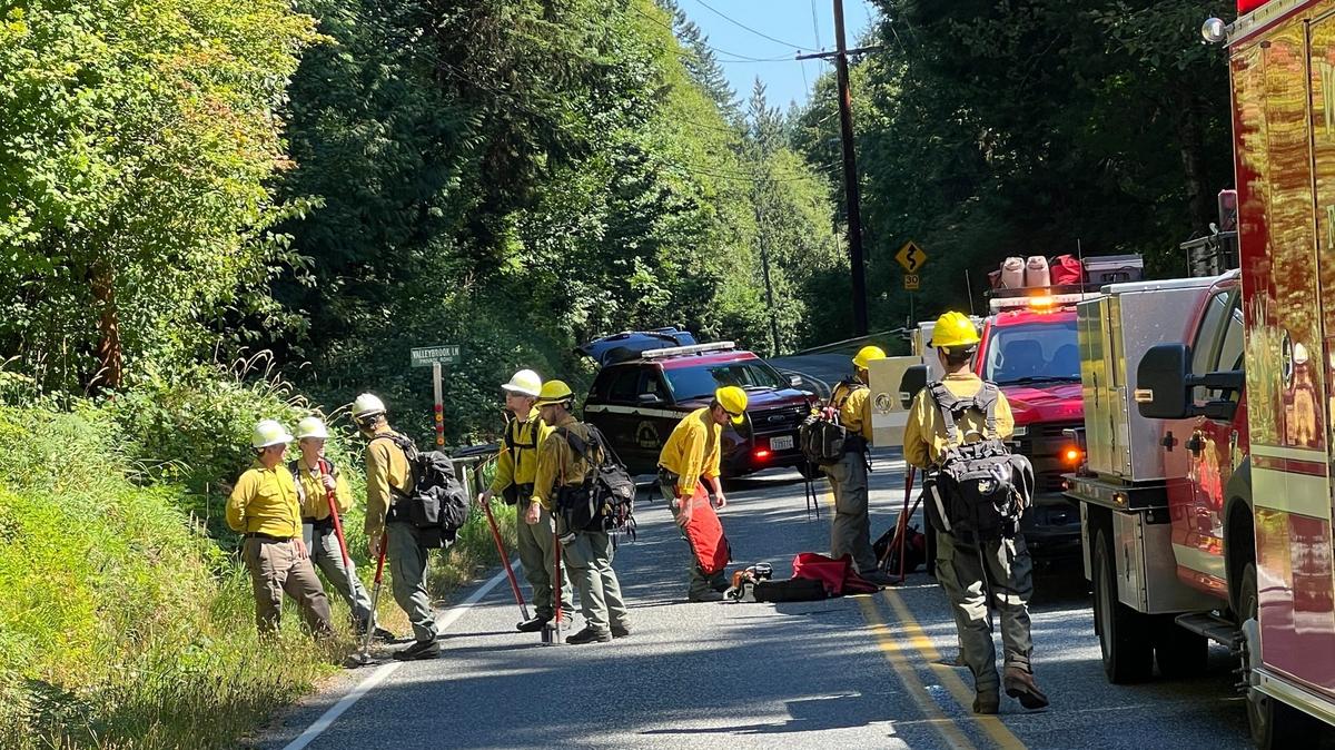 Washington State Department of Natural Resources wildland firefighters are shown along Lake Louise Road as they get ready to fight a wildfire in Stimpson Family Nature Reserve on Aug. 14, 2023.