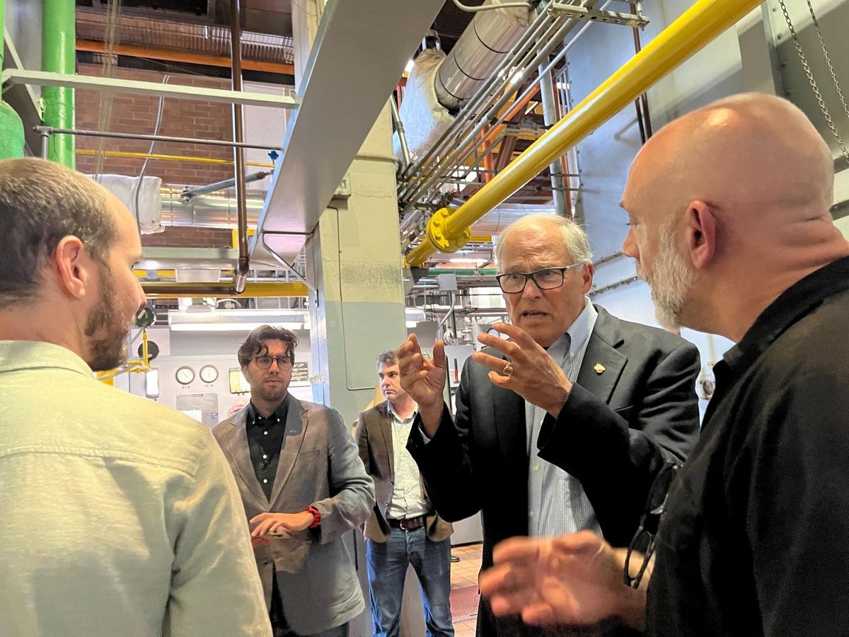 Washington Gov. Jay Onslee chats with Western Washington University officals during a tour of the Steam Plant to check on Climate Commitment Act progress. Inslee and WWU officials went to the Steam Plant and its underground tunnels and to the new Kaiser-Borsari Building on Wednesday, Sept. 11, 2024.