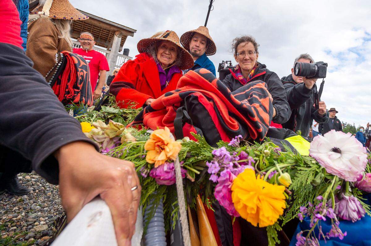 Lummi Nation elders Lutie Hillaire, center left, and Raymond Hillaire gift a blanket to members of the Skul-itch (Octopus) Canoe Family from Tacoma during the Gathering of the Eagles canoe landing celebration at the Lummi Stommish grounds on Friday afternoon May 27, on the Lummi Reservation in Whatcom County.