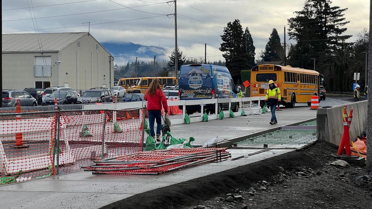 A dog-walker crosses the Meador Avenue bridge over Whatcom Creek on Tuesday. The bridge is open after a several-month closure to replace the span, which dates to 1962.