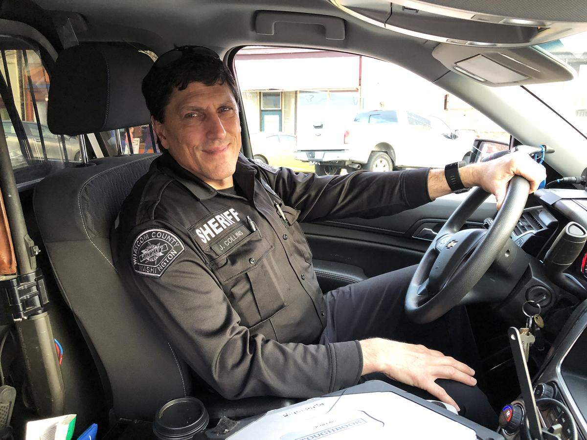 Crisis Intervention Deputy Jamie Collins, in his squad car in downtown Bellingham in January, spends much of his day working with and responding to behavioral health-related calls to the Whatcom County Sheriff’s Office.