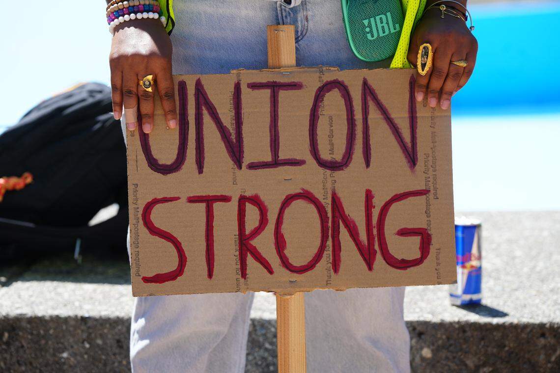 An Operational Student Employee holds a “Union Strong” sign at a strike action at Western Washington University in May 2025.