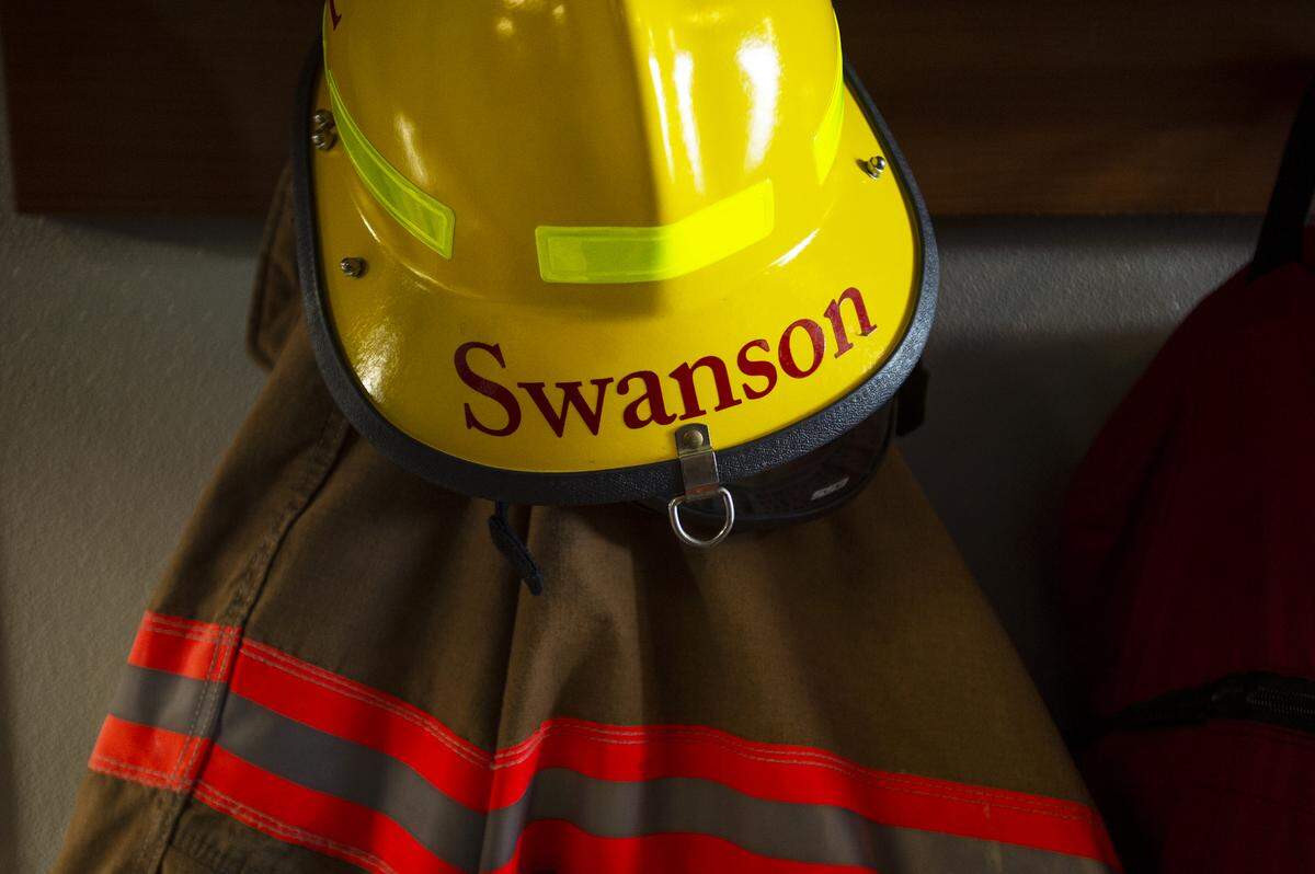 Firefighter Ron Swanson’s turnout gear hangs in the engine bay of the South Whatcom Fire Station 21 in the Geneva area of Bellingham.