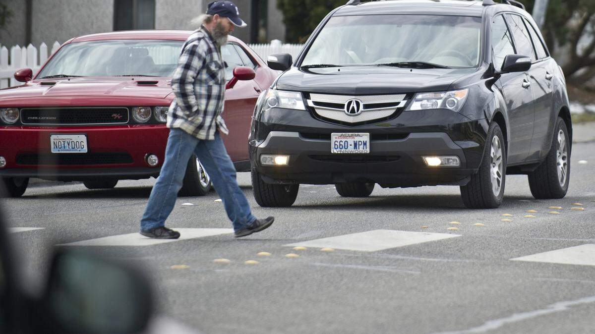 A pedestrian walks across the crosswalk at St. Paul Street and Alabama Street in Bellingham in this 2014 file photo.