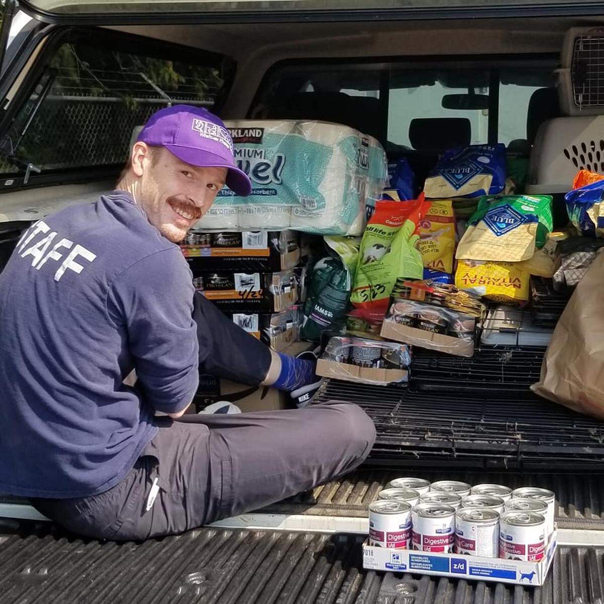 Whatcom Humane Society customer service staff member Mark Henry loads a truckload of supplies to take to the Humane Society of Skagit Valley after that organization seized more than 100 puppies from property near Sedro-Woolley on Sept. 2.