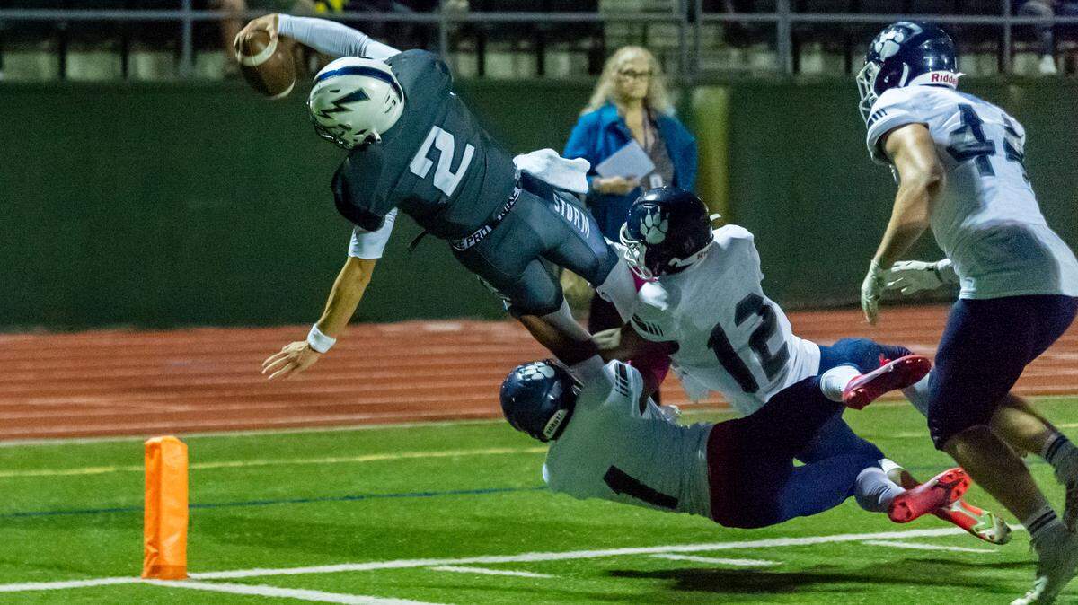 Squalicum quarterback Leyton Smithson reaches for the goal line as Lynden Christian defensive backs Zac Owen (1) and Sam Penner (12) stop Smithson short of a touchdown as he reaches over the pylon during the second quarter on Friday evening Sept. 3, at Civic Field in Bellingham. Squalicum defeated Lynden Christian 40 to 14 in their season opener.