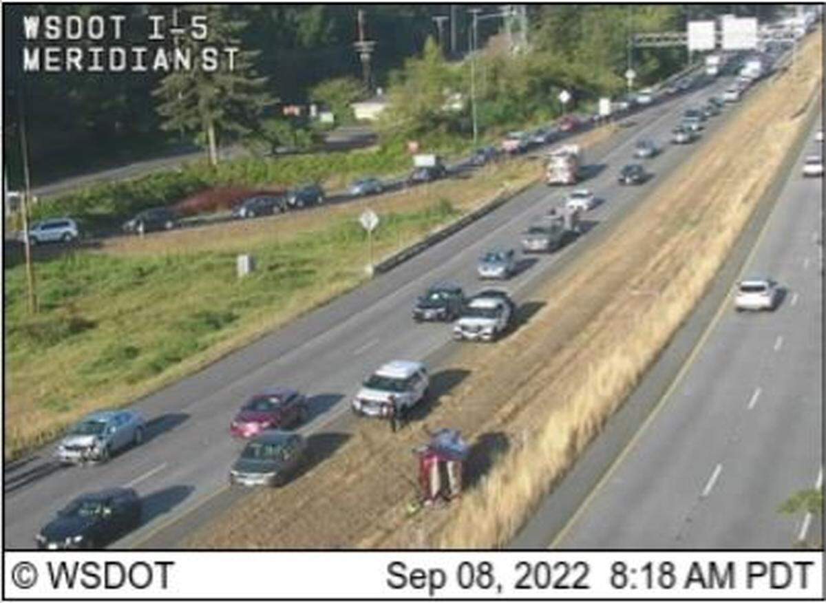 A car rests on its side in the median of Interstate 5 south of the southbound Meridian Street exit Thursday morning, Sept. 8, in Bellingham.