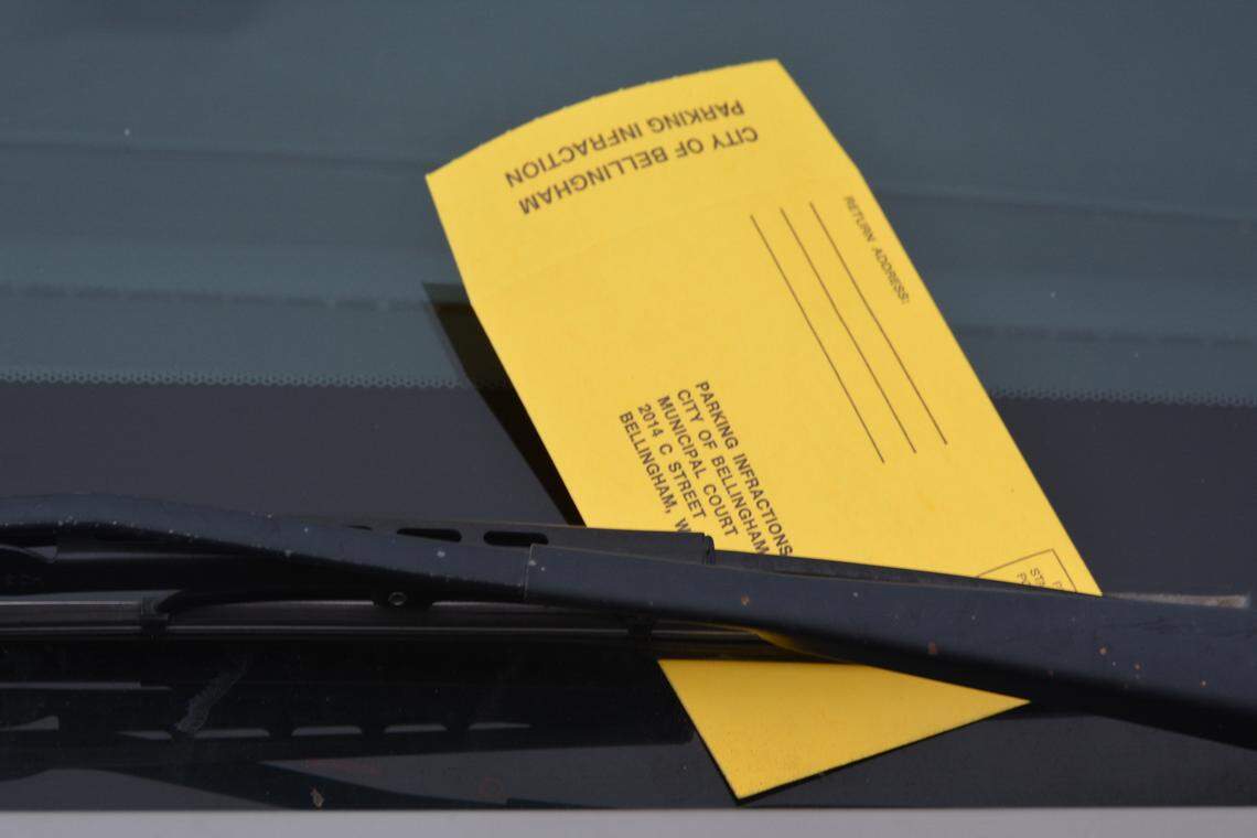 A parking ticket is tucked under the wipers of a car on Flora Street near the County Courthouse in downtown Bellingham
