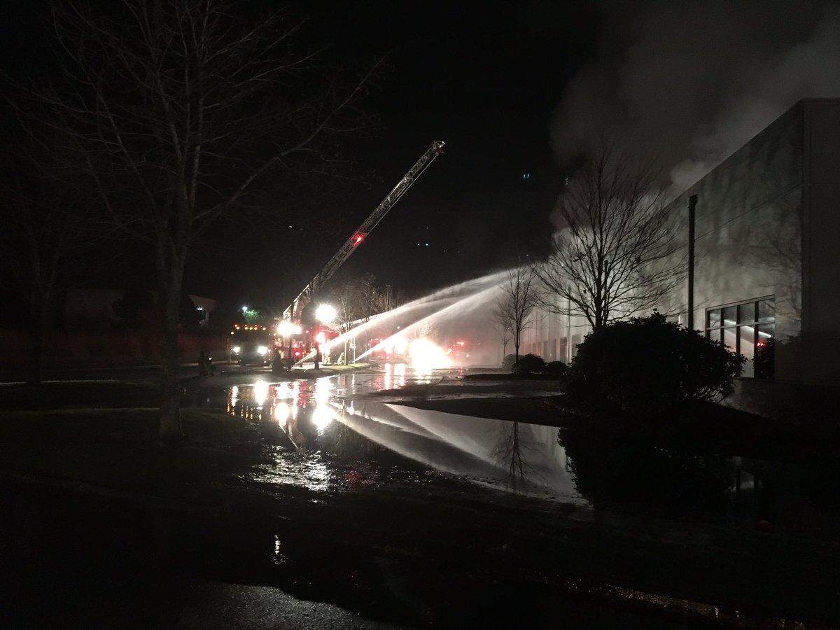 Bellingham firefighters shoot heavy streams of water into the Blue Sea Systems building early Saturday morning.