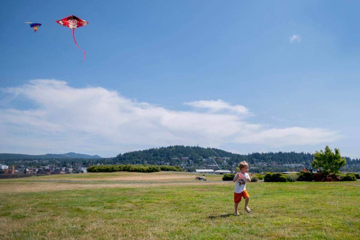 Owen Huckstep, 3, flies his kite in the sunshine at Zuanich Point Park on Wednesday, July 28, 2021, in Bellingham, Wash. A high temperature of 87 degrees is forecast for Bellingham on Friday, July 30, 2021, but the Mount Baker foothills and areas near the Canadian border will be much warmer, according to the National Weather Service in Seattle.