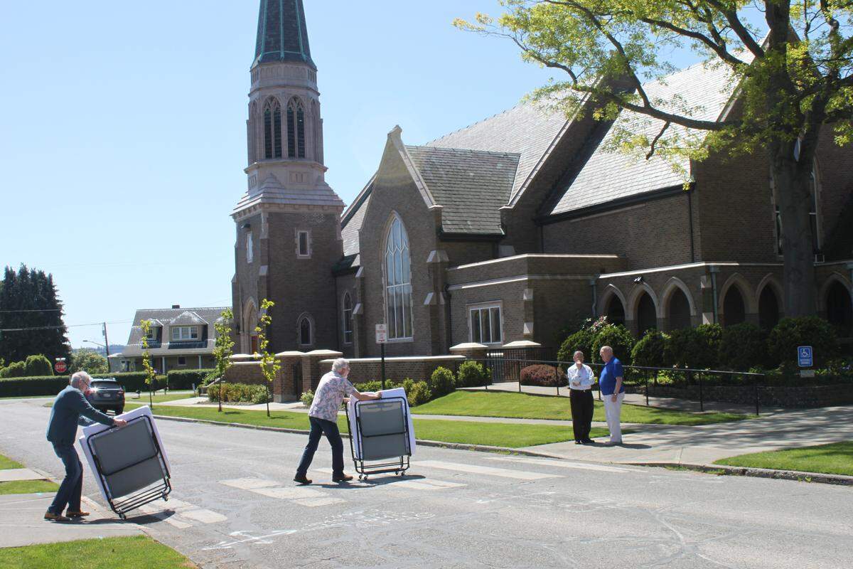 Volunteers move beds from a trailer into St Paul’s Episcopal Church, a Family Promise host congregation, in Bellingham in summer 2018.