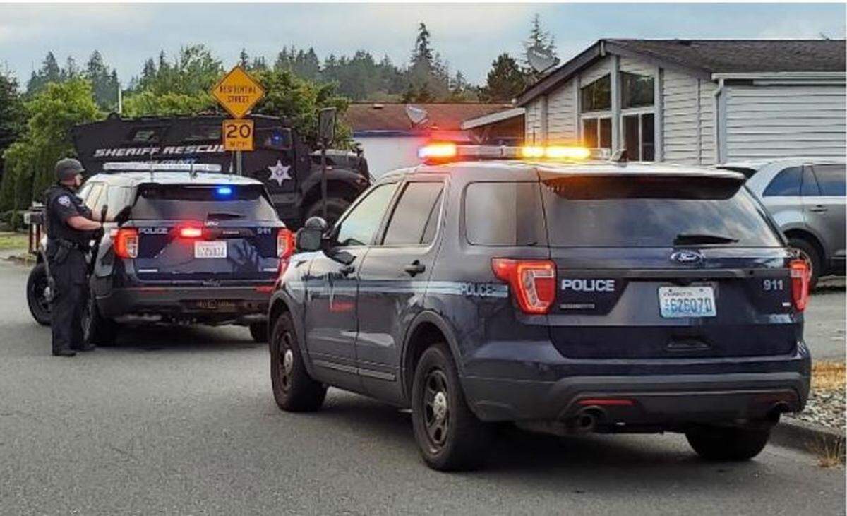 Members of the Mount Vernon Police, assisted by the Skagit County Sheriff’s Office, Washington State Patrol and Sedro Woolley and Burlington police departments, serve warrants at two locations in Mount Vernon Friday, July 22, in connection with the Sunday, July 17, shooting at Walmart that injured five people. One youth was arrested.