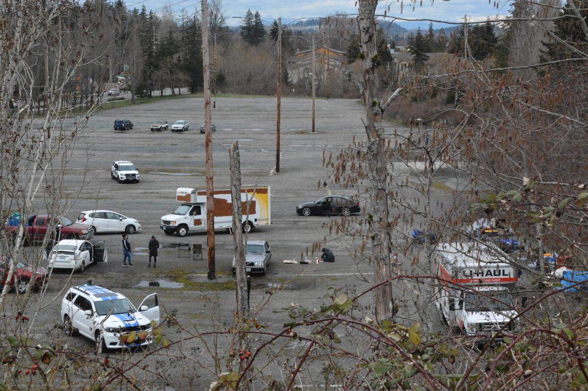 Western Washington University Police meet protesters and homeless people who moved from an encampment at Laurel Park at the Lincoln Creek Park & Ride in Bellingham Friday afternoon, March 19. The university does not allow camping at the parking lot.