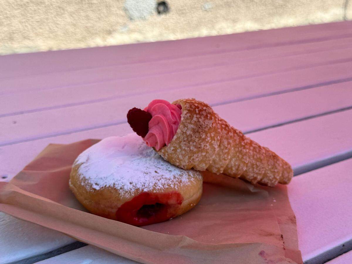 A raspberry donut and raspberry cream puff horn from Lynden Dutch Bakery at The Northwest Raspberry Festival in downtown Lynden, Wash. on Friday, July 19, 2024.