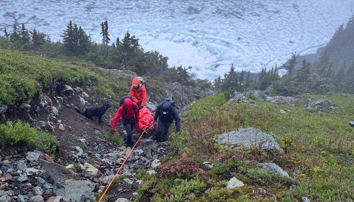 Team members from Bellingham Mountain Rescue navigate a steep hillside below Winchester Lookout while moving an injured hiker in this undated photo.