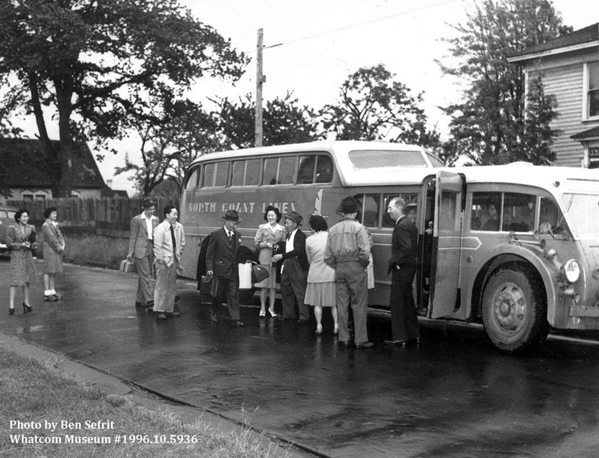 A bus waits to take Bellingham residents of Japanese descent to Burlington as part of the first leg of their journey to an internment camp in Tule Lake, Calif. It was parked on H Street, according to a caption in the June 4, 1942, edition of The Bellingham Herald.