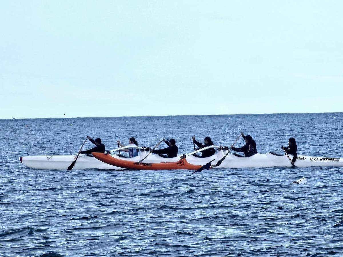 Members of the Xw’lemi Outrigger Racing Association paddle an outrigger canoe.