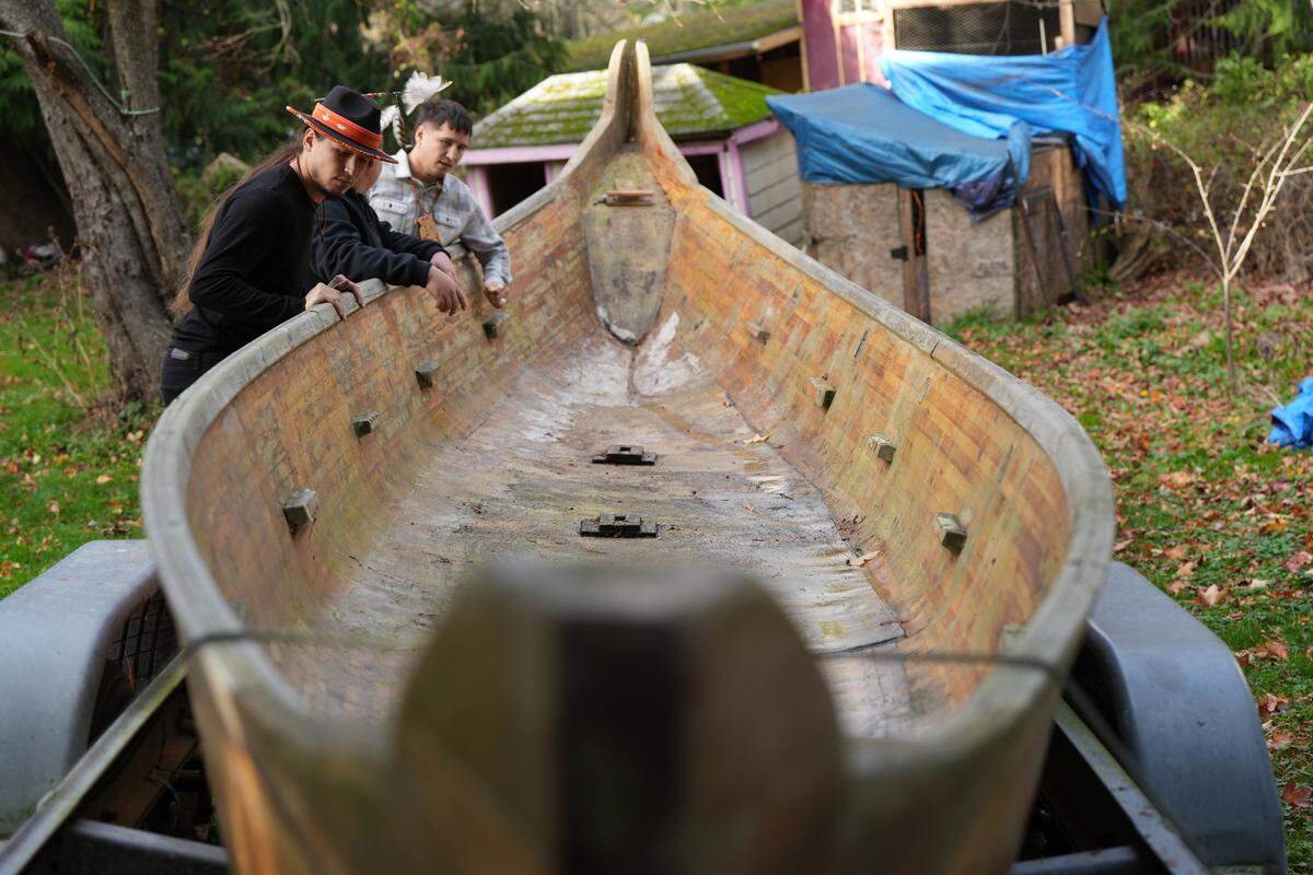 Twin brothers Free and Raven Borsey look at a canoe they plan to refurbish as part of their efforts to revitalize the Lummi Youth Canoe Family on the Lummi Reservation.